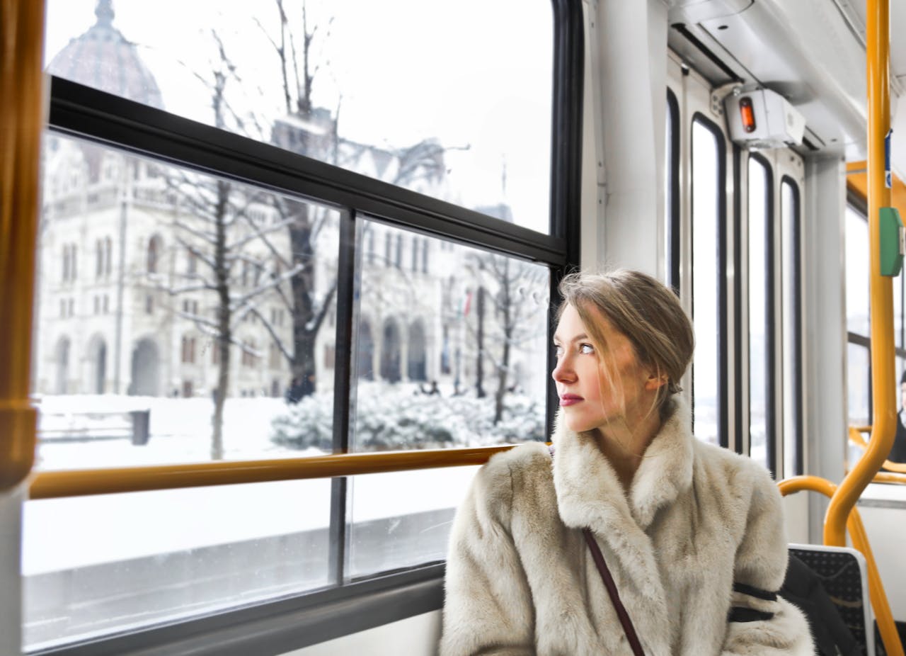 Cam young woman in warm clothes in public transport